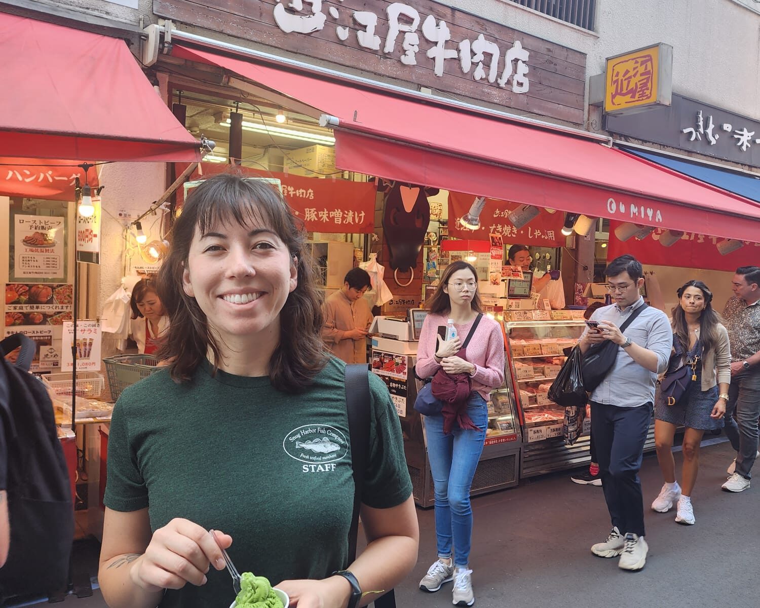Kylie in her Snug Harbor Fish merch outside of the famous Tsukiji Fish Market in Japan